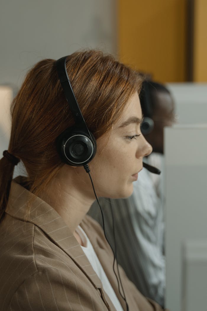 A Woman in Brown Blazer Wearing Black Headphones